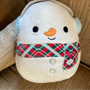 SQUISHMALLOWS Mannie the Snowman wears a sporty plaid scarf and earmuffs. Cute!